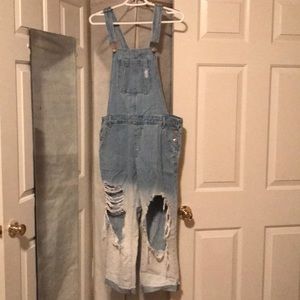 Blue to light wash ombre overalls with rips.